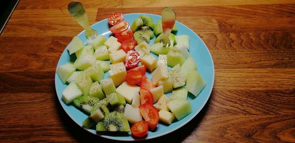 High angle view of chopped fruits in bowl on table