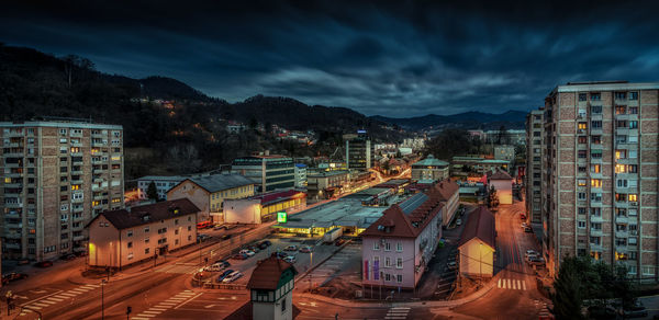 High angle view of illuminated cityscape against sky at dusk