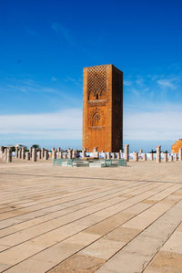 Built structure on beach against blue sky