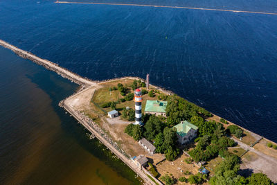 Aerial view of the lighthouse at the river bank and the sea.