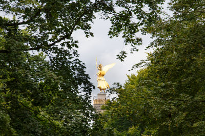Low angle view of statue against trees