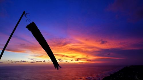 Windsock silhouette on the beach sunset