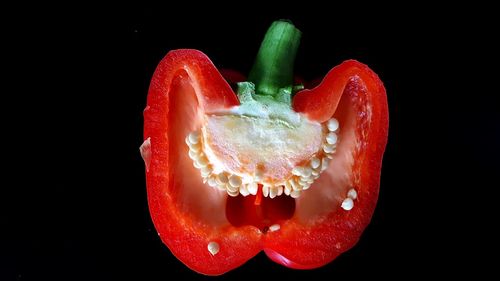 Close-up of red bell pepper over black background