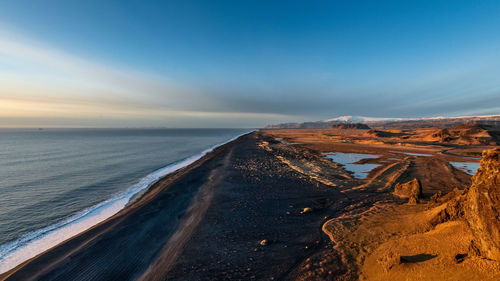 Scenic view of beach against sky during sunset