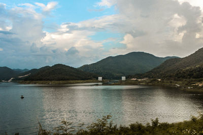 Scenic view of lake and mountains against sky