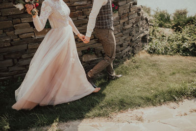 Bride and groom walking outdoors