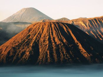 Scenic view of volcanic mountain against sky