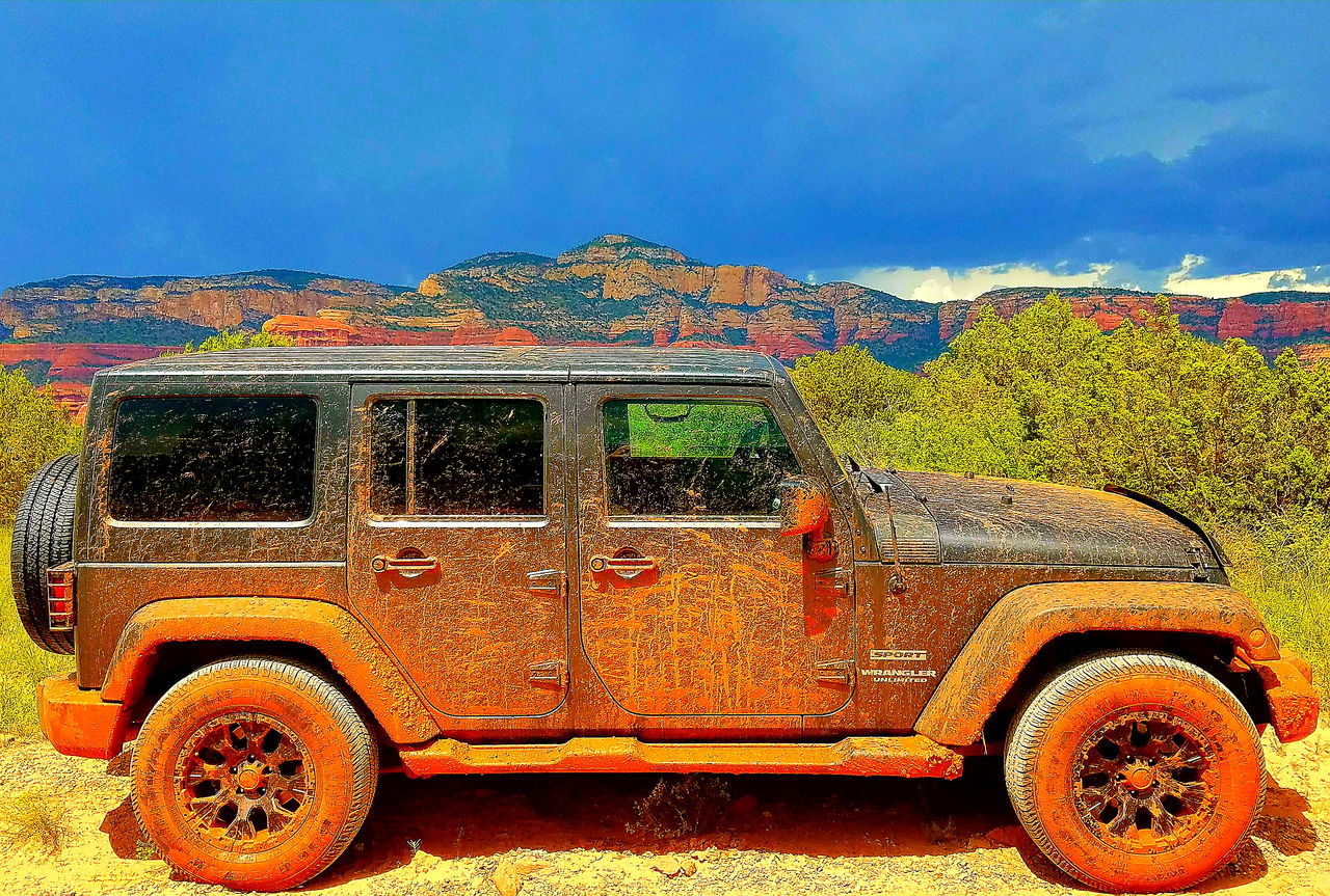 CAR ON MOUNTAIN AGAINST SKY