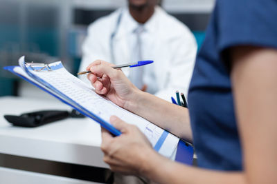 Cropped image of man holding hands on table