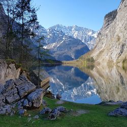 Scenic view of lake and mountains against clear sky