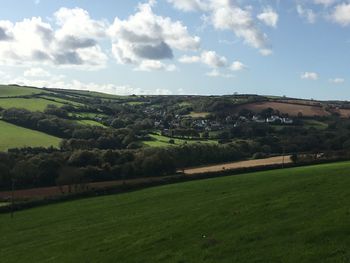Scenic view of agricultural field against sky