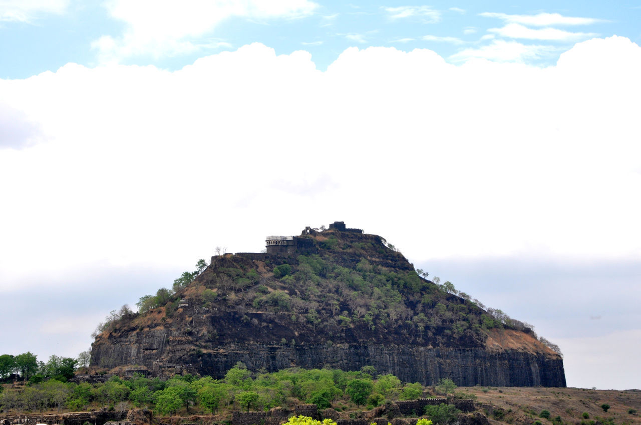 LOW ANGLE VIEW OF ROCK FORMATION ON MOUNTAIN AGAINST SKY