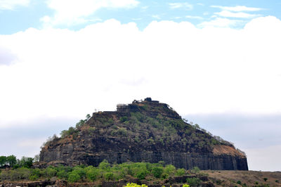 Low angle view of rock formations against sky