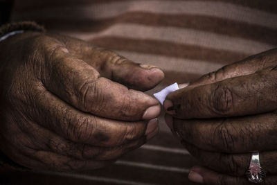 Close-up of man holding cigarette