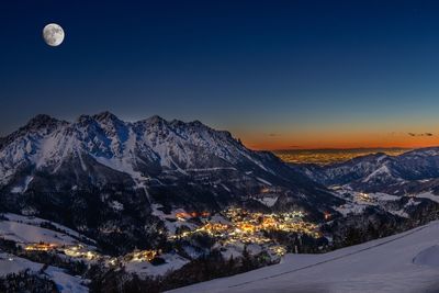 Scenic view of snowcapped mountains against sky at night