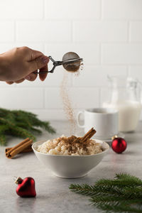 Cropped hand of person preparing food on table