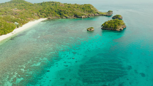 Tropical sandy beach near the blue lagoon and corall reef, aerial view boracay, philippines. 