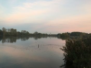 Scenic view of calm lake against sky