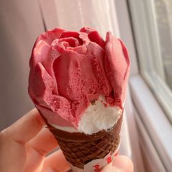 Close-up of hand holding ice cream cone