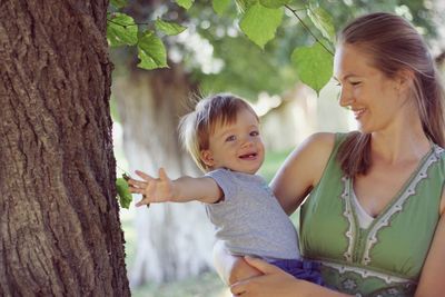 Mother and son on tree trunk