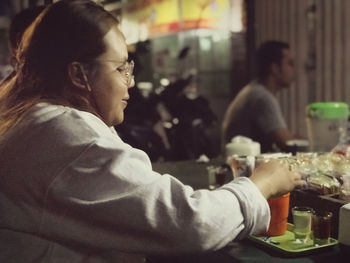 Portrait of woman sitting at restaurant table