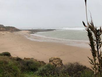 Scenic view of beach against clear sky