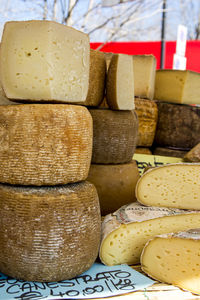 Stacked cheese for sale at market stall