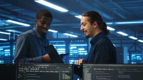 Side view of man using digital tablet in office