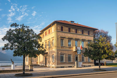  the beautiful palazzo verbania in luino in the golden hour with blue sky and white clouds