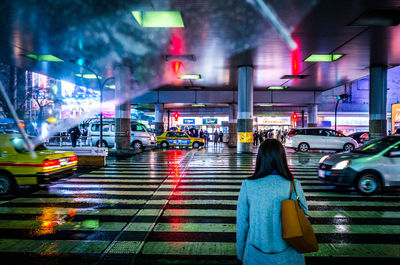 Man in illuminated city at night