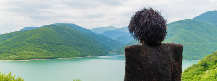 Rear view of two people looking at mountains