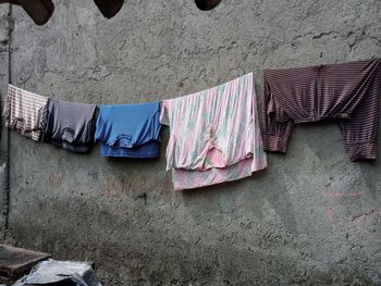 Low angle view of clothes drying against wall