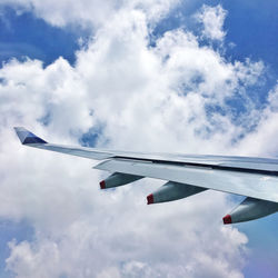 Low angle view of airplane flying against sky