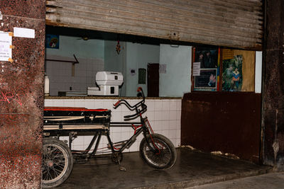 Bicycle parked on street against building