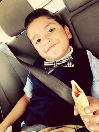 Portrait of boy sitting in car