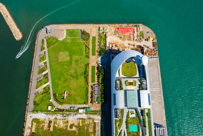 High angle view of information sign by sea against building