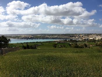 Scenic view of landscape against cloudy sky