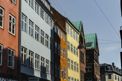 Low angle view of buildings against clear blue sky