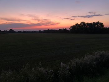 Scenic view of field against sky during sunset