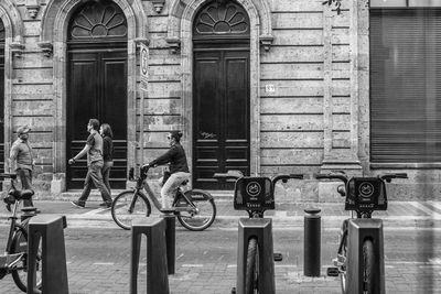 People on wall in city