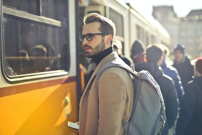 Side view of man standing in city