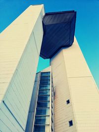 Low angle view of modern building against clear blue sky