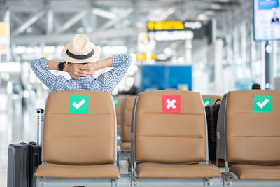 Full length of man wearing hat while sitting in bus