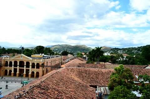 architecture, building exterior, built structure, sky, cloud - sky, house, mountain, cloudy, residential structure, cloud, town, roof, residential building, day, residential district, tree, outdoors, village, townscape, street