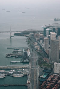 High angle view of buildings by sea against sky