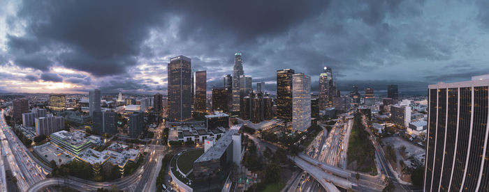 Panoramic view of buildings against cloudy sky