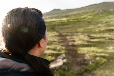 Rear view of woman looking at camera