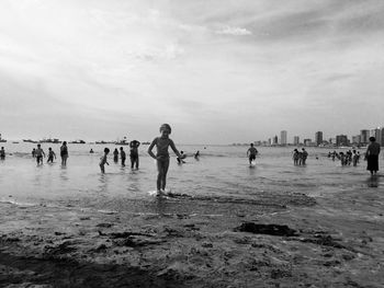 People on beach against sky