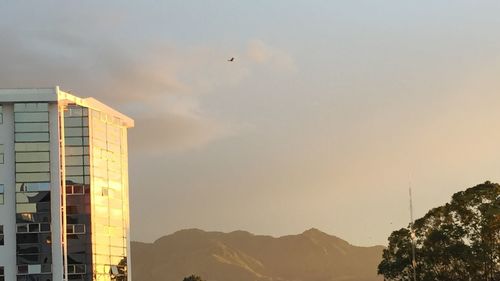 Low angle view of buildings against sky during sunset