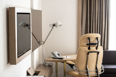 Electric lamp on table by window at home